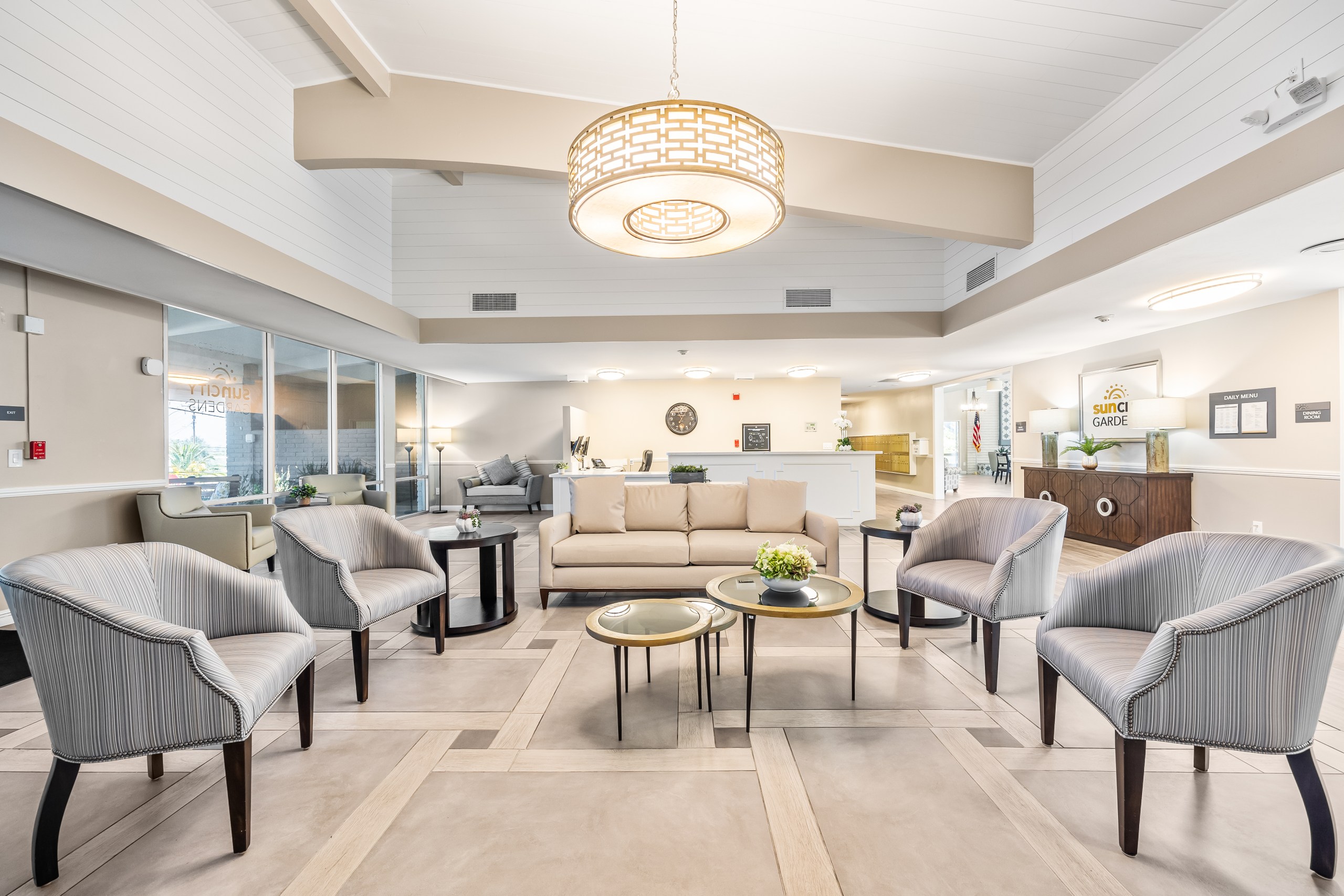 A living room with a grey sofa and matching armchairs.